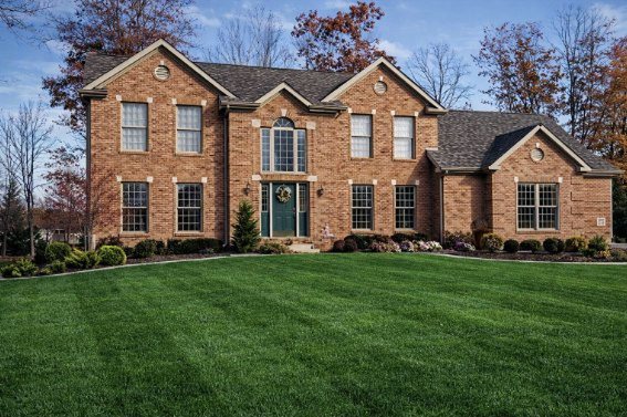 Stonebrook, a red brick two-story custom home with gabled wings